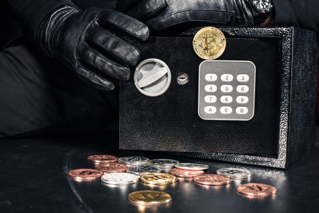 Close-up view of man opening safe with bitcoin cryptocurrency